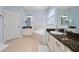 Bright bathroom featuring double sinks, granite countertops, and a relaxing soaking tub at 918 Emerald Green Ct, Kissimmee, FL 34746