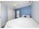 Bedroom with blue accent wall, ceiling fan and a large window at 918 Emerald Green Ct, Kissimmee, FL 34746