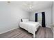 Bright bedroom featuring wood floors and a window with dark curtains, creating a serene space at 918 Emerald Green Ct, Kissimmee, FL 34746