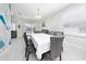 Elegant dining room with tile floors, a large table, and a view of the backyard, ideal for Gathering meals at 918 Emerald Green Ct, Kissimmee, FL 34746