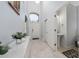 Bright foyer boasts high ceilings, tile floors, and a view of the front door and a conveniently located half-bath at 918 Emerald Green Ct, Kissimmee, FL 34746