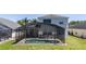 Enjoy the screened-in pool with ample seating and a beautiful view of the home and backyard at 918 Emerald Green Ct, Kissimmee, FL 34746