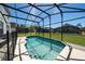Swimming pool inside screened enclosure overlooking green backyard at 918 Emerald Green Ct, Kissimmee, FL 34746