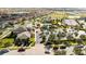 Aerial view showcasing community amenities with a clubhouse, swimming pool, tennis courts, and ample parking at 9895 Winnington St, Orlando, FL 32832