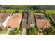 Aerial view of a home with a red tile roof, well-maintained landscaping, and a private pool at 9895 Winnington St, Orlando, FL 32832
