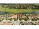 Aerial view of a home with tile roof, near a golf course, situated within a well-maintained residential community at 9895 Winnington St, Orlando, FL 32832