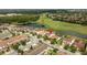 Stunning aerial view of home nestled on a manicured golf course with a serene lake at 9895 Winnington St, Orlando, FL 32832