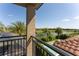 Tranquil balcony view overlooking a lush backyard, swimming pool, and peaceful lake surrounded by palm trees at 9895 Winnington St, Orlando, FL 32832