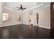 The primary bedroom includes dark hardwood floors, and views into the en-suite bathroom at 9895 Winnington St, Orlando, FL 32832