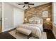 Cozy bedroom features a decorative wood accent wall behind the bed, a neutral color scheme, and soft lighting at 9895 Winnington St, Orlando, FL 32832