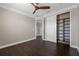 Bedroom featuring a closet with built-in shelving, hardwood floors, neutral walls, and ceiling fan at 9895 Winnington St, Orlando, FL 32832