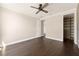 Bedroom features dark wood floors, and access to a walk-in closet at 9895 Winnington St, Orlando, FL 32832