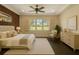 Bright primary bedroom with a large window overlooking landscaped yard at 9895 Winnington St, Orlando, FL 32832
