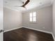Bedroom featuring hardwood floors, neutral walls, a ceiling fan and a window with shutters at 9895 Winnington St, Orlando, FL 32832