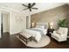 Comfortable bedroom features neutral tones, an accent wall, hardwood floors, and soft natural light at 9895 Winnington St, Orlando, FL 32832