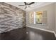 Bedroom featuring a ceiling fan, decorative wall, and abundant natural light through the window at 9895 Winnington St, Orlando, FL 32832