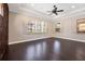Bright bedroom showcasing dark hardwood floors, recessed lights, and large windows offering a scenic outdoor view at 9895 Winnington St, Orlando, FL 32832