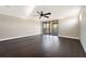 Open bonus room features dark wood floors, recessed lighting, ceiling fan, and sliding glass doors at 9895 Winnington St, Orlando, FL 32832