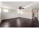 Spacious bonus room with neutral paint, dark wood floors, and multiple windows, offering plenty of natural light at 9895 Winnington St, Orlando, FL 32832
