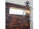 A close up of the wrought iron chandelier and accent wall on the upper level at 9895 Winnington St, Orlando, FL 32832