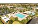 Aerial view of a large community pool featuring lounge chairs, covered cabanas, and lush tropical landscaping at 9895 Winnington St, Orlando, FL 32832