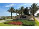 Welcoming entrance to Eagle Creek featuring lush landscaping and elegant stone signage at 9895 Winnington St, Orlando, FL 32832