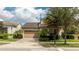 Charming home featuring a two-car garage, well-maintained landscaping, and a beautiful tile roof at 9895 Winnington St, Orlando, FL 32832