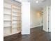 Hallway with wood floors showcasing built-in shelving and white trim at 9895 Winnington St, Orlando, FL 32832