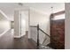 Upstairs hallway features dark wood floors, iron railing and chandelier at 9895 Winnington St, Orlando, FL 32832