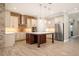 Gourmet kitchen with stainless steel appliances and center island with wood base at 9895 Winnington St, Orlando, FL 32832