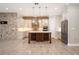 A modern kitchen with stainless steel appliances, a large island, and stone backsplash at 9895 Winnington St, Orlando, FL 32832