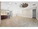 Open floor plan showcasing kitchen with island and breakfast bar extending to dining and living areas at 9895 Winnington St, Orlando, FL 32832