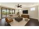 Bright living room features contemporary furnishings, dark hardwood floors, and sliding glass doors to outdoor space at 9895 Winnington St, Orlando, FL 32832