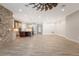 Open floor plan: brick accent wall, modern kitchen, spacious living areas at 9895 Winnington St, Orlando, FL 32832