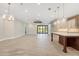 Bright, open-concept living space with tile floors, modern lighting, and seamless access to the outdoor area at 9895 Winnington St, Orlando, FL 32832