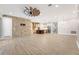 Open-concept kitchen and living area showcasing a brick accent wall and wood-look tile at 9895 Winnington St, Orlando, FL 32832