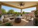 Inviting covered outdoor patio featuring comfortable seating and a serene view of the surrounding trees and lake at 9895 Winnington St, Orlando, FL 32832