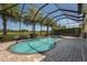 Inviting pool and spa in a screened enclosure, with lush landscaping and golf course views at 9895 Winnington St, Orlando, FL 32832
