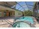 Inviting screened-in pool with spa and spacious patio area, perfect for outdoor entertaining at 9895 Winnington St, Orlando, FL 32832