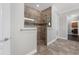 Modern tiled glass shower with built-in seat and tiled accent stripe at 9895 Winnington St, Orlando, FL 32832