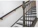 Staircase features wrought iron spindles and stained wood trim at 9895 Winnington St, Orlando, FL 32832