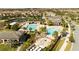 Aerial view of community pools, clubhouse, lounge area, splashpad, and lush landscaping at 9895 Winnington St, Orlando, FL 32832