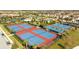 Aerial view of community tennis and basketball courts nestled amongst lush landscaping and residential housing at 9895 Winnington St, Orlando, FL 32832