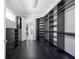 Spacious walk-in closet with dark hardwood floors, custom built-in shelving and cabinetry at 9895 Winnington St, Orlando, FL 32832
