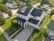 Stunning aerial view of a home showcasing its lush landscaping, a brick driveway, and manicured hedges at 1114 Georgia Blvd, Orlando, FL 32803