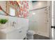 Fun bathroom featuring shower, vanity and decorative jellyfish-themed wallpaper at 1114 Georgia Blvd, Orlando, FL 32803