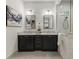 Chic bathroom with double vanities, quartz countertops, black cabinets, and a walk-in glass shower at 1114 Georgia Blvd, Orlando, FL 32803