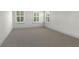 Bright bedroom with neutral carpet, three windows with white shutters and fresh, white walls at 1114 Georgia Blvd, Orlando, FL 32803