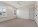 Clean, bright bedroom with a ceiling fan, shuttered windows and a neutral-colored carpet at 1114 Georgia Blvd, Orlando, FL 32803