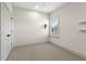 Bright, minimalist bedroom with neutral carpet, window with shutters, and closet at 1114 Georgia Blvd, Orlando, FL 32803
